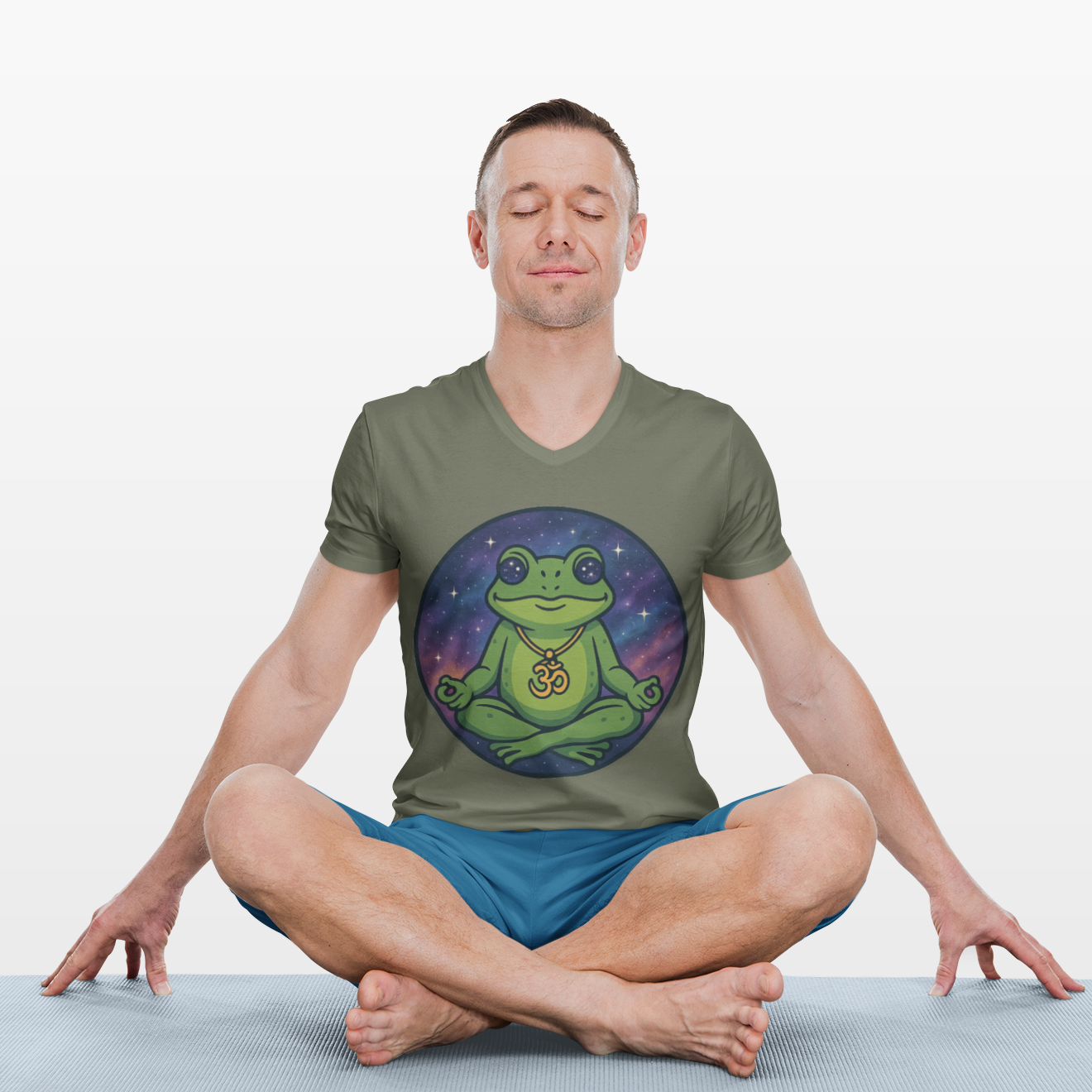 Man sitting in a yoga pose wearing a t-shirt with a frog graphic design on a white background
