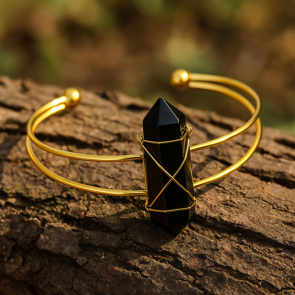 Gold bracelet with a black crystal on a wooden surface